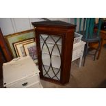 A mahogany and inlaid glazed corner cabinet