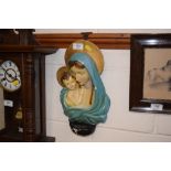 A painted plaster religious wall plaque