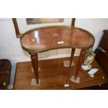 A French inlaid kidney shaped table with brass gal