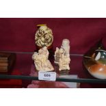 A small collection of oriental resin figures