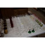 A large collection of various drinking glasses