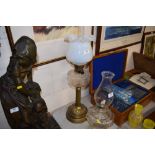 An Art Nouveau brass and glass oil lamp