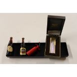 A boxed lighter; two miniature Guinness bottles et