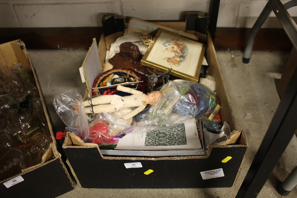 A box of various sundries, prints, a doll etc.