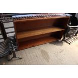 An open fronted two tier bookcase