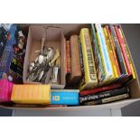 A box of books and cutlery