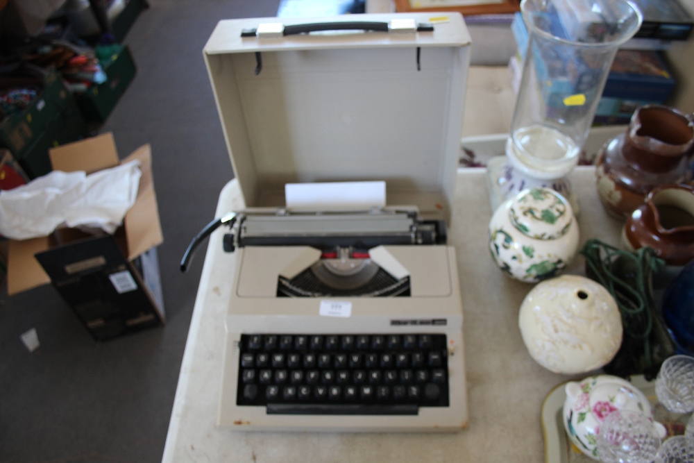 A Mairtsa portable typewriter in carrying case