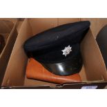 A box containing a holster and cap