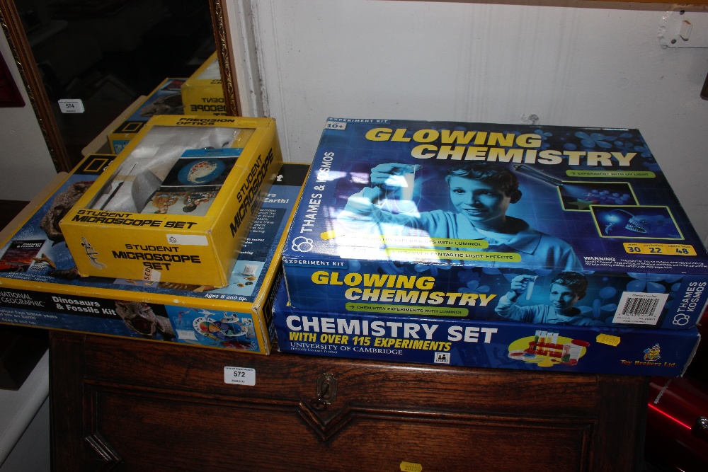 Two Glowing chemistry sets together with a student