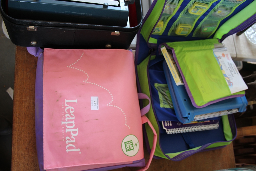 Two Leap Frog learning systems in carrying cases
