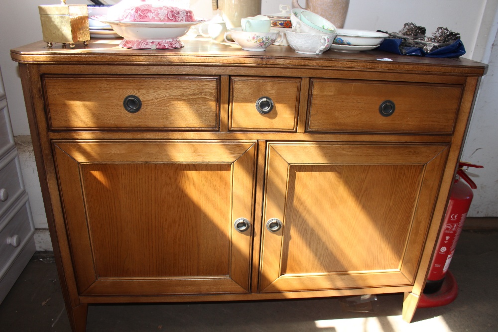 An oak sideboard fitted three drawers