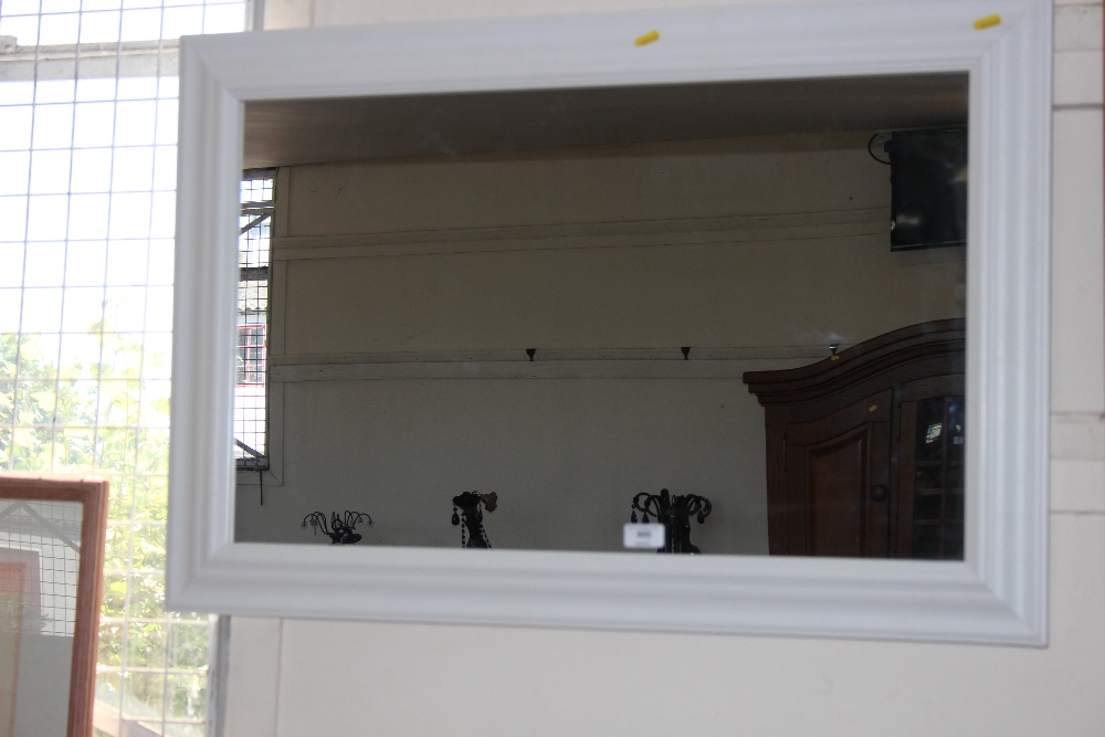 A white framed wall mirror