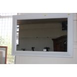 A white framed wall mirror