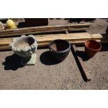 A concrete garden urn and two other planters