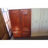 A modern pine two door wardrobe fitted two drawers