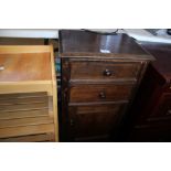 An oak bedside cupboard fitted two drawers