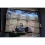 A box of various postcards; German stamps etc