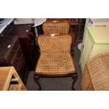 A pair of mahogany and cane seated chairs