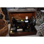 A Singer hand sewing machine in carrying case