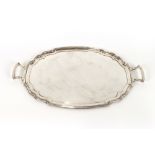 A large rectangular electro plated two handled drinks tray, with stylised foliate engraved border,