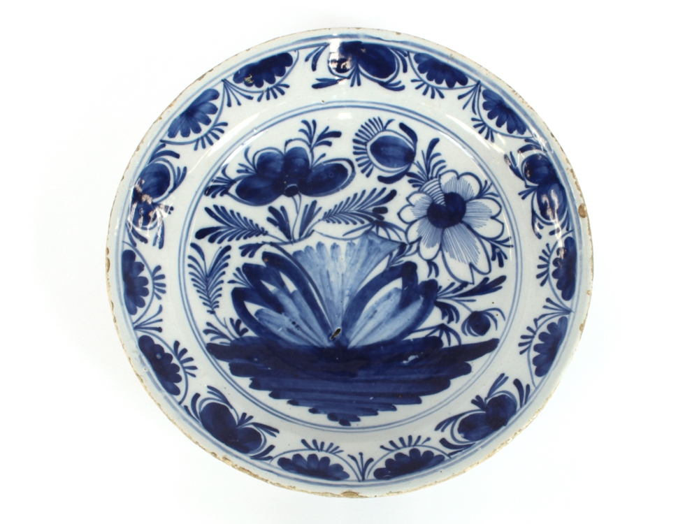 An 18th Century Delft shallow dish, with stylised floral decoration, 36cm dia.