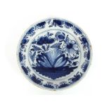 An 18th Century Delft shallow dish, with stylised floral decoration, 36cm dia.