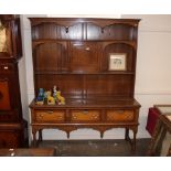 An 18th Century oak and pollard cross-banded Welsh dresser, the shelved and boarded back fitted with