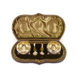 A cased pair of Victorian circular silver salts, raised on ball feet, Birmingham 1894; and a pair of