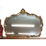 A gilt framed Florentine style wall mirror, of cartouche shape with shell and foliate scroll