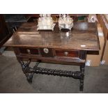 An Antique oak side table, the over hanging top above a single moulded front drawer, raised on