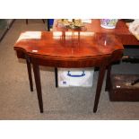 A 19th Century mahogany serpentine fronted tea table, raised on square section tapering supports,