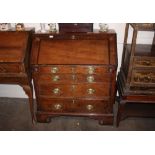 An Antique oak bureau, the fall front opening to reveal an interior arrangement of drawers and