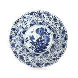 A Chinese blue and white Kanghsi platter, having raised decoration and shaped border, 27.5cm dia.