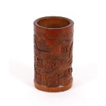 A finely carved 19th Century Chinese bamboo brush pot, decorated with figures, landscapes and