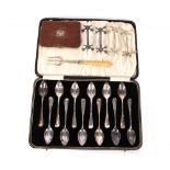 A cased set of 12 plated grapefruit spoons; two pairs of plated knife rests; a silver and ivory