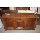 A 17th Century oak coffer, having double panelled lid and triple fielded panel front, raised on