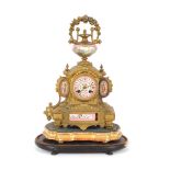 A 19th Century French gilded mantel clock, having Sevres type panels, decorated flowers and cherubs,