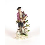 A fine 19th Century Meissen porcelain figure, depicting a shepherd playing pipes with sheep and