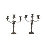 A pair of Victorian ornate plated three light candelabra, with profuse foliate decoration, 38cm wide
