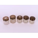 Five various silver mounted glass tidies and toilet jars