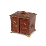 A Regency leather covered table cabinet, fitted four drawers and raised on brass foliate feet,