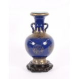 A 19th Century Chinese powder blue and gilt decorated baluster porcelain vase, having flared neck,