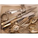 A quantity of silver teaspoons; a silver napkin ring; a plated ham bone holder; and other items