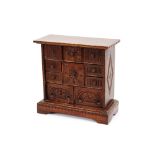 An Antique carved oak spice cupboard, fitted with an arrangement of 10 drawers, 46cm wide x 45cm