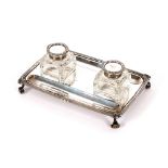 An  Edwardian silver desk stand, by the Goldsmith & Silversmiths Company, fitted two block glass