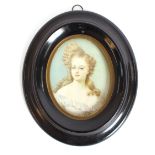 A 19th Century hand painted miniature portrait, of a fashionable young lady, in oval ebonised frame