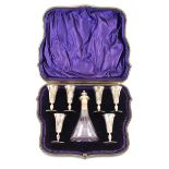 A small silver mounted decanter, and six miniature goblets, London 1911, (cased)