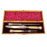 A late Victorian light oak and inlaid cased three piece carving set, having horn handles and