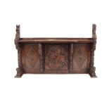 An impressive Victorian carved oak triple panel overmantel, the centre panel decorated with St.