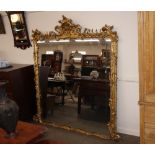 A large early 19th Century rococo design gilt framed mirror, (formerly from Hurts Hall,